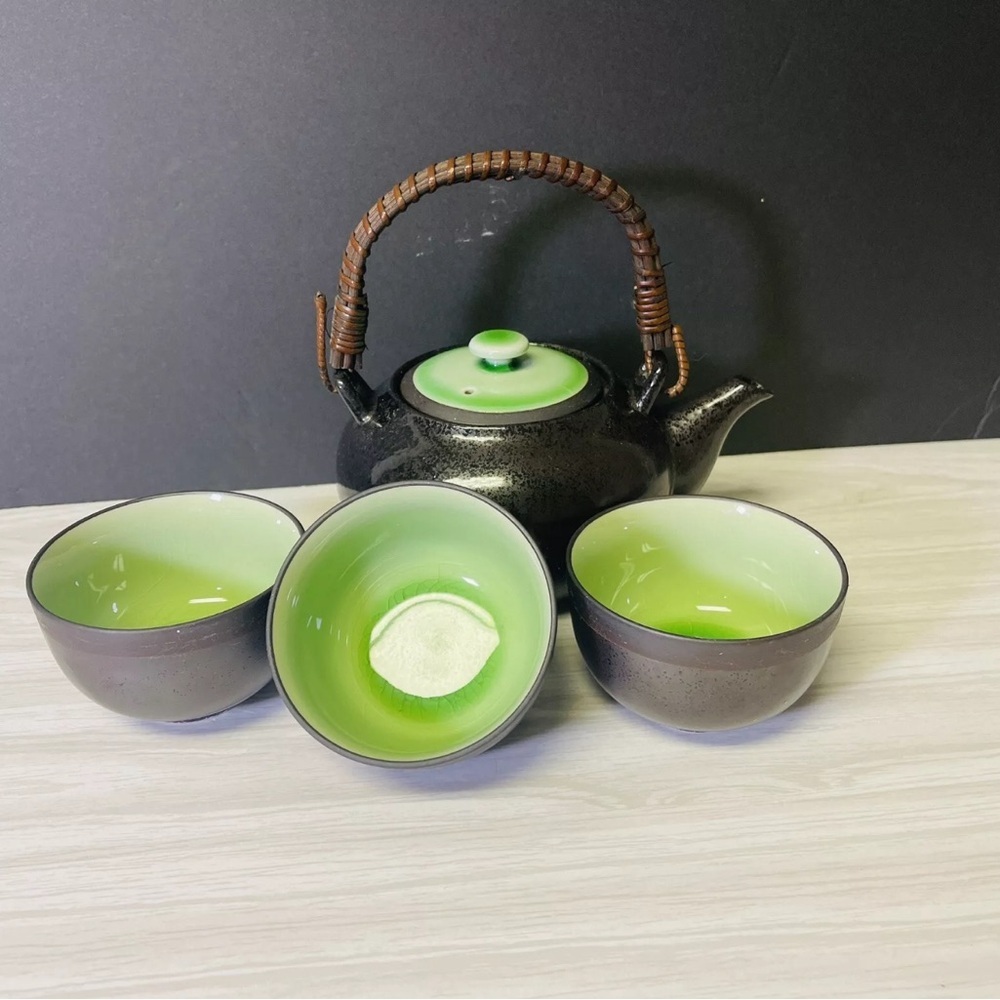 Tea set four asian-inspired Sake/tea cups and wood handled teapot.